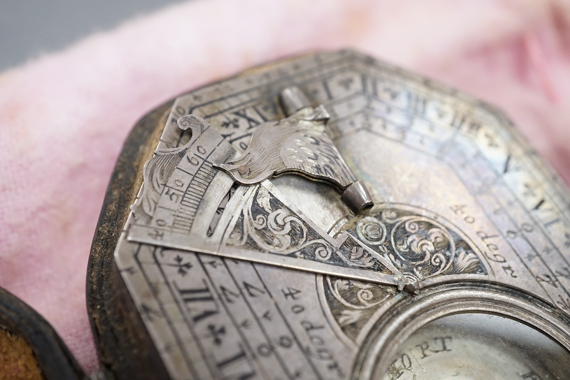 An early 18th century French silvered Butterfield pattern pocket sundial by Bion, Paris, with engraved octagonal plate and the gnomen supported by birds, the reverse engraved with the latitudes of various European cities